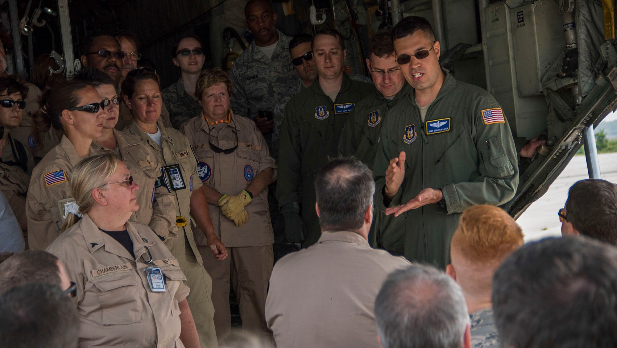 TOLEDO, Ohio - Master Sgt. Steven Mauter, 445th Aeromedical Evacuation Squadron AE technician, instructs members of the Disaster Medical Assistance Team and Navy Expeditionary Medical Facility on proper litter loading techniques on board a C-130 Hercules aircraft June 7, 2015. The exercise, which took place June 4-7, 2015, brought together: the Air National Guard, Air Force Reserve, Army Reserve, Navy Reserve, U.S. Special Operations Command, U.S. Customs and Border Patrol, the Toledo Police Department, and other local police and fire departments who observed the activities. (U.S. Air Force photo/Senior Airman Devin Long)