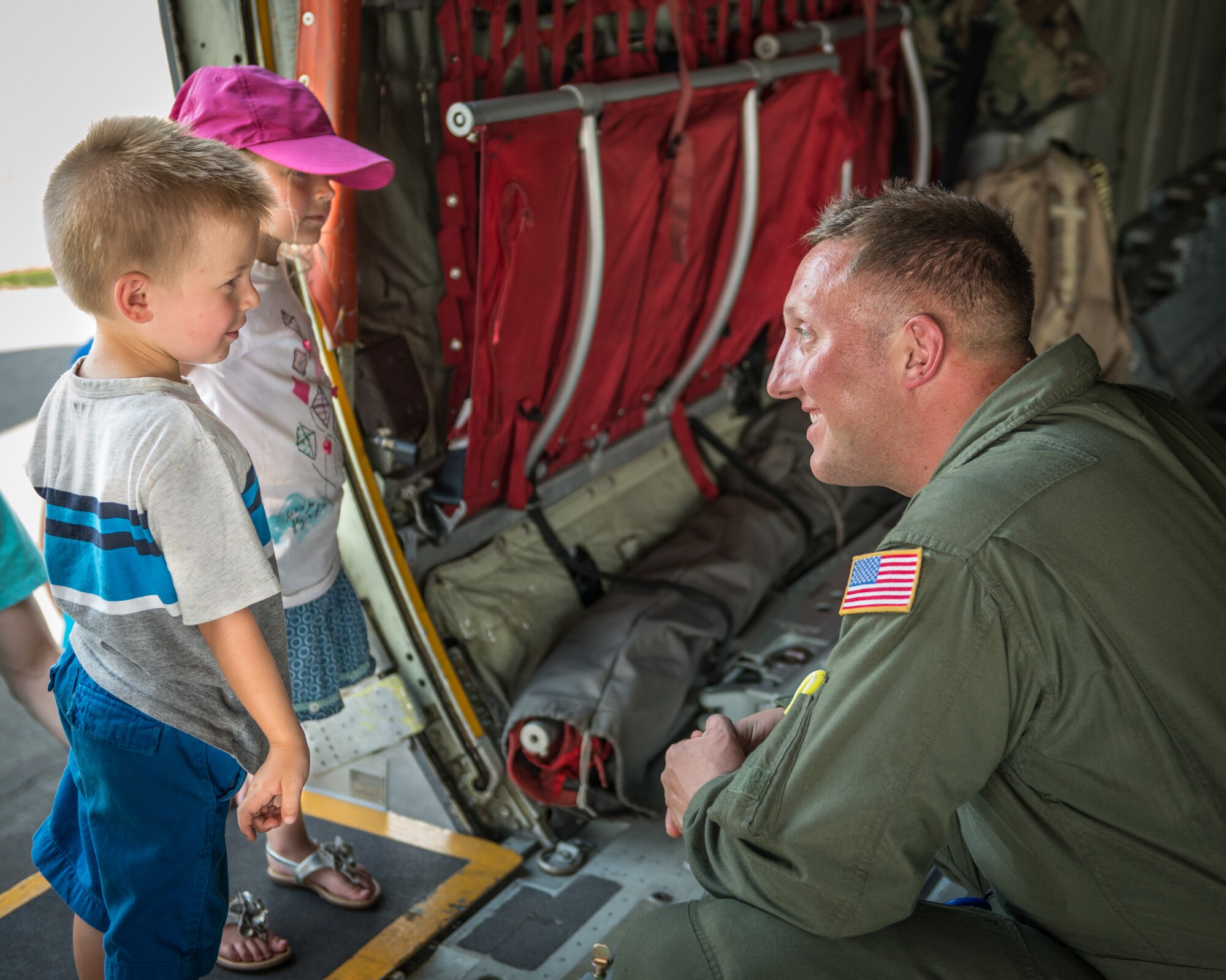 Tech. Sgt. Jesse Toombs, 934th Aeromedical Evacuation Squadron, talks to a couple of young spectators during the Minnesota Air Spectacular in Mankato, Minn.   Members of the 934th Airlift Wing provided static tours of a C-130 aircraft during the air show June 27-28, which also included aerial performances, highlighted by the U.S. Air Force Thunderbirds.  (U.S. Air Force photo by Shannon McKay/Released)