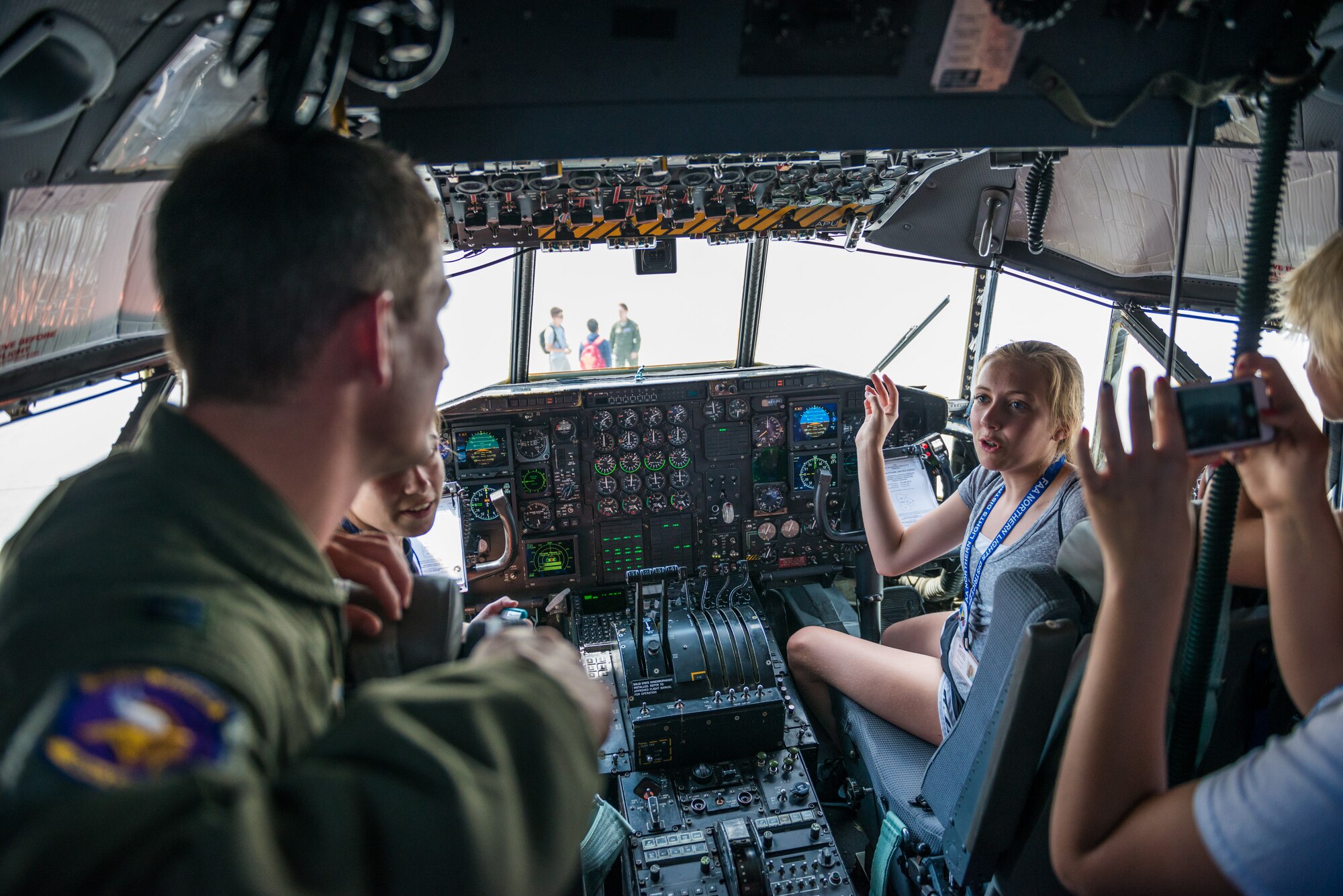 Sophie Jensen, a student enrolled in the Minnesota Aviation Career Education Camp, talks with Capt. Daniel Schei, 96th Airlift Squadron, about flight simulators versus real life aircraft during a tour of a 934th Airlift Wing C-130 aircraft at the Minneapolis-St. Paul Air Reserve Station, Minn. ACE Camp is a week-long, residential camp for high school students that allows them to explore many different careers in the aviation field, including piloting, air traffic control, engineering, and the military. (U.S. Air Force photo by Shannon McKay/Released)