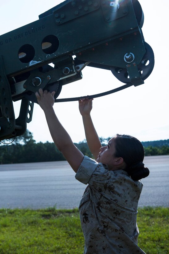 Marine Corps Lance Cpl. Mayra A. Tamayo performs a preflight check of all working components on an RQ7B Shadow unmanned aerial vehicle at Marine Corps Air Station Cherry Point, N.C., July 1, 2015. Tamayo is an unmanned aerial vehicle operator assigned to Marine Unmanned Aerial Vehicle Squadron 2.