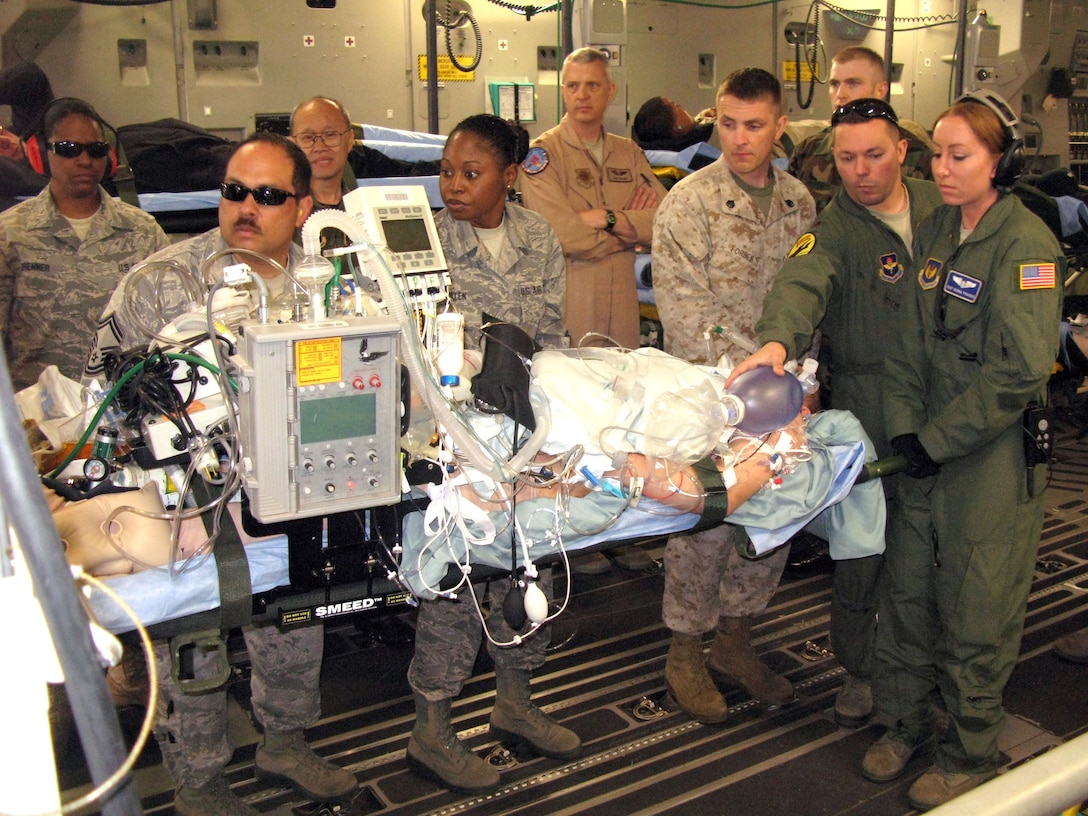 U.S. Air Force aeromedical evacuation crewmembers and volunteers at Ramstein Air Base, Germany, position a critically wounded warrior for a flight aboard a C-17 Globemaster III to Joint Base Andrews, Maryland, April 29, 2011. (U.S. Air Force photo by Donna Miles)