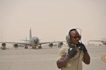 Technical Sgt. Ellison Cason, 340th Expeditionary Aircraft Maintenance Unit, communicates with the aircrew on function checks during pre-flight inspections for a KC-135 Stratotanker June 7, 2015 Al Udeid Air Base, Qatar.
