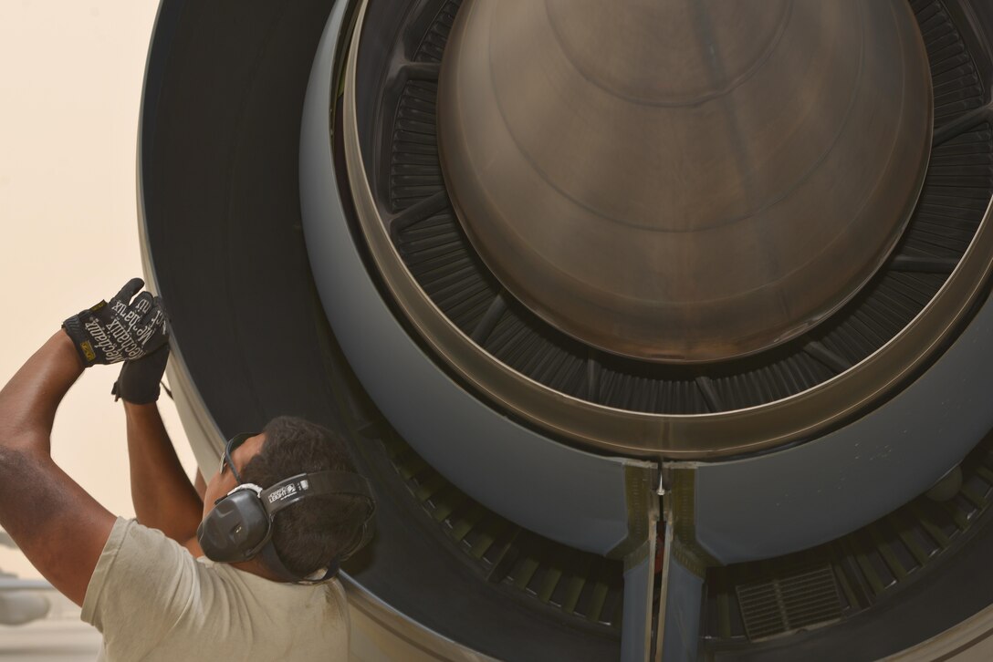 Airman 1st Class Jonathan Palacios-Conde, 340th Expeditionary Aircraft Maintenance Unit, snaps together a locking device on a KC-135 Stratotanker engine cover during pos-flight inspections June 7, 2015 Al Udeid Air Base, Qatar.   