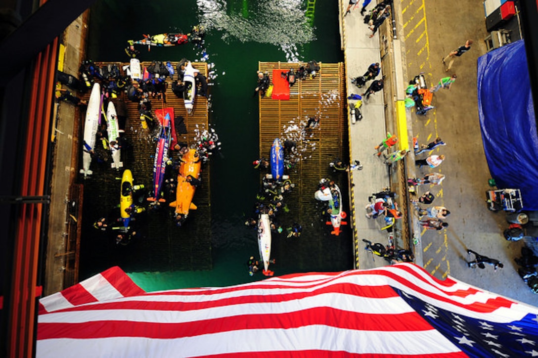 WEST BETHESDA, Md. (June 24, 2015) Submarines and their team members wait in the staging area during the 13th International Human-Powered Submarine Race (ISR) being held in the David Taylor Model Basin at the Naval Surface Warfare Center Carderock Division. The International Human-Powered Submarine Race inspires Science, Technology, Engineering, and Math (STEM) students to explore the broad areas of underwater technology and to provide an educational experience that translates their theoretical knowledge into reality. (U.S. Navy Photo by Mass Communication Specialist 1st Class Clifford L. H. Davis/Released)