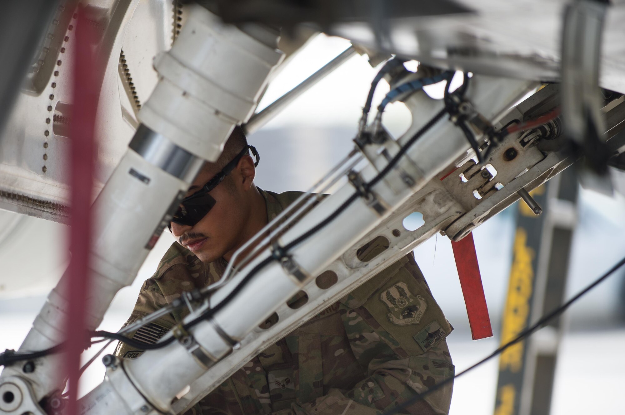 U.S. Air Force Airman 1st Class Manuel Jimenez, 455th Expeditionary Aircraft Maintenance Squadron crew chief, performs a preflight inspection on an F-16 Fighting Falcon aircraft at Bagram Airfield, Afghanistan, July 7, 2015. The F-16 is a multi-role fighter aircraft that is highly maneuverable and has proven itself in air-to-air and air-to-ground combat. (U.S. Air Force photo by Tech. Sgt. Joseph Swafford/Released)