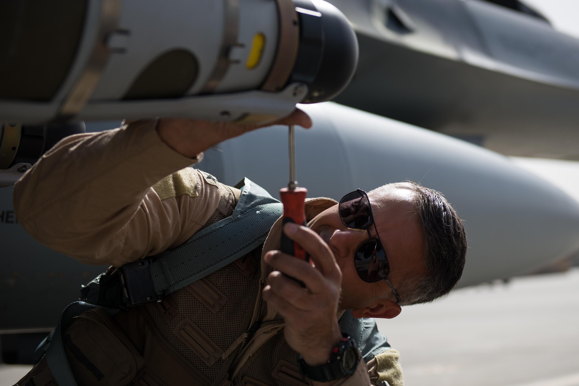 U.S. Air Force Brig. Gen. Dave Julazadeh, 455th Air Expeditionary Wing commander, completes preflight procedures on an F-16 Fighting Falcon aircraft before his first combat sortie July 7, 2015, at Bagram Airfield, Afghanistan. The F-16 is a multi-role fighter aircraft that is highly maneuverable and has proven itself in air-to-air and air-to-ground combat. (U.S. Air Force photo by Tech. Sgt. Joseph Swafford/Released)