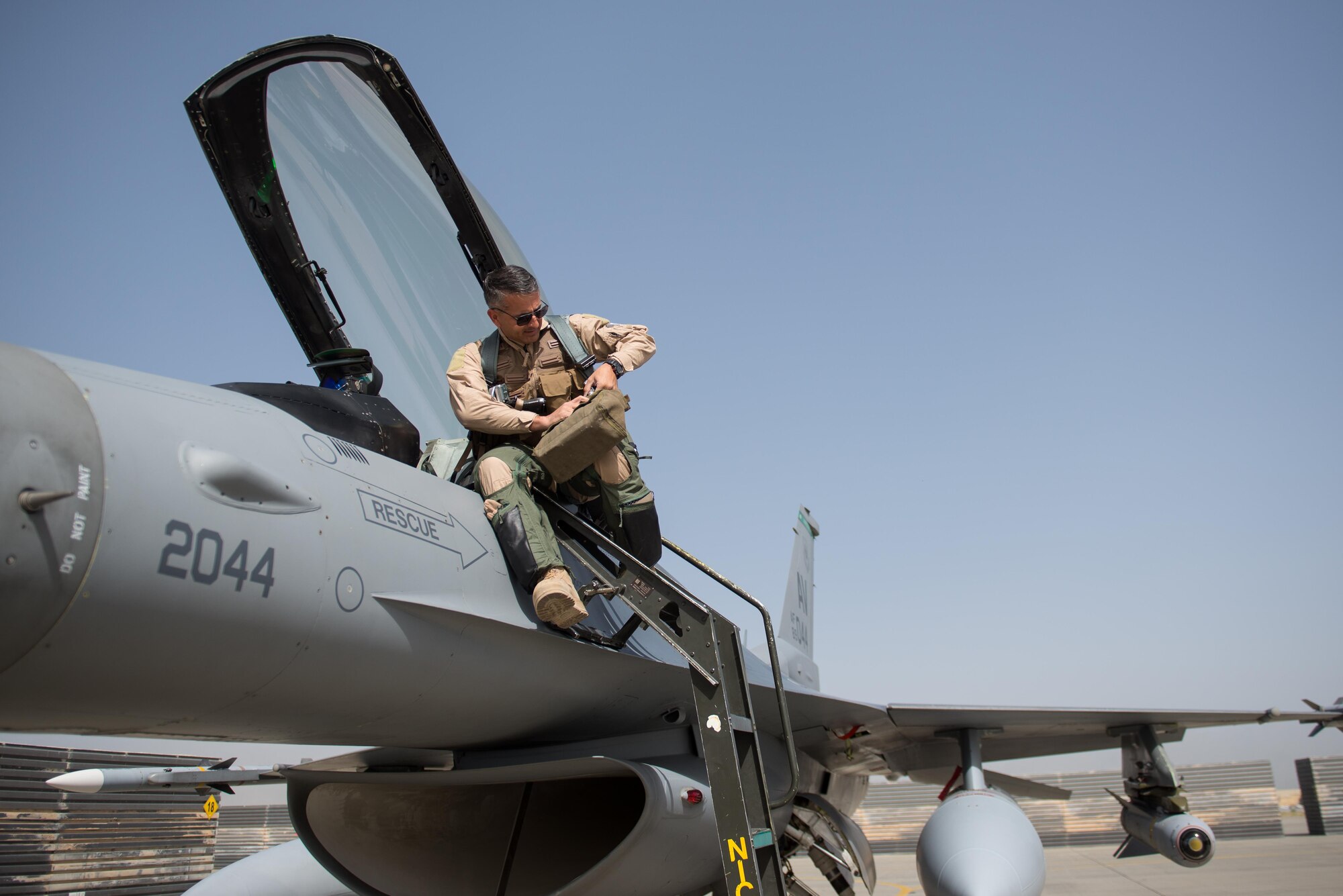 U.S. Air Force Brig. Gen. Dave Julazadeh, 455th Air Expeditionary Wing commander, enters an F-16 Fighting Falcon aircraft before flying a combat sortie July 7, 2015, at Bagram Airfield, Afghanistan. Julazadeh was flying his first combat sortie as commander of the 455th AEW. (U.S. Air Force photo by Tech. Sgt. Joseph Swafford/Released)