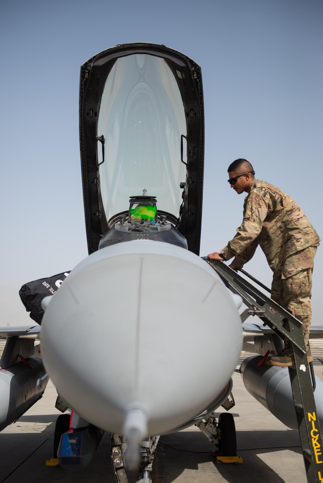 U.S. Air Force Brig. Gen. Dave Julazadeh, 455th Air Expeditionary Wing commander, and Airman 1st Class Manuel Jimenez, 455th Expeditionary Aircraft Maintenance Squadron crew chief, perform an F-16 Fighting Falcon aircraft preflight inspection July 7, 2015, at Bagram Airfield, Afghanistan. Julazadeh was flying his first combat sortie as commander of the 455th AEW. (U.S. Air Force photo by Tech. Sgt. Joseph Swafford/Released)