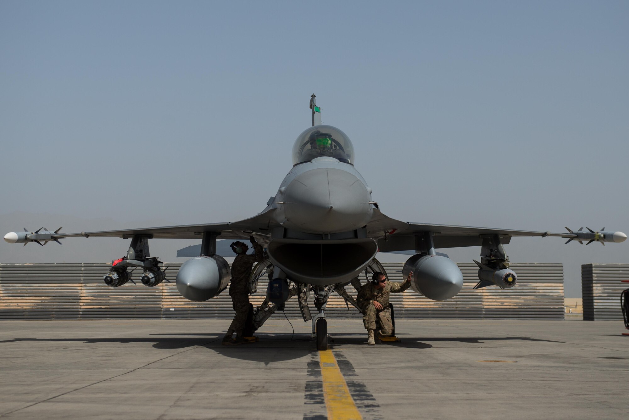 U.S. Air Force Brig. Gen. Dave Julazadeh, 455th Air Expeditionary Wing commander, goes over preflight checks in an F-16 Fighting Falcon aircraft with Airmen assigned to the 455th Expeditionary Aircraft Maintenance before flying a combat sortie July 7, 2015, at Bagram Airfield, Afghanistan. Julazadeh was flying his first combat sortie as commander of the 455th AEW. (U.S. Air Force photo by Tech. Sgt. Joseph Swafford/Released)