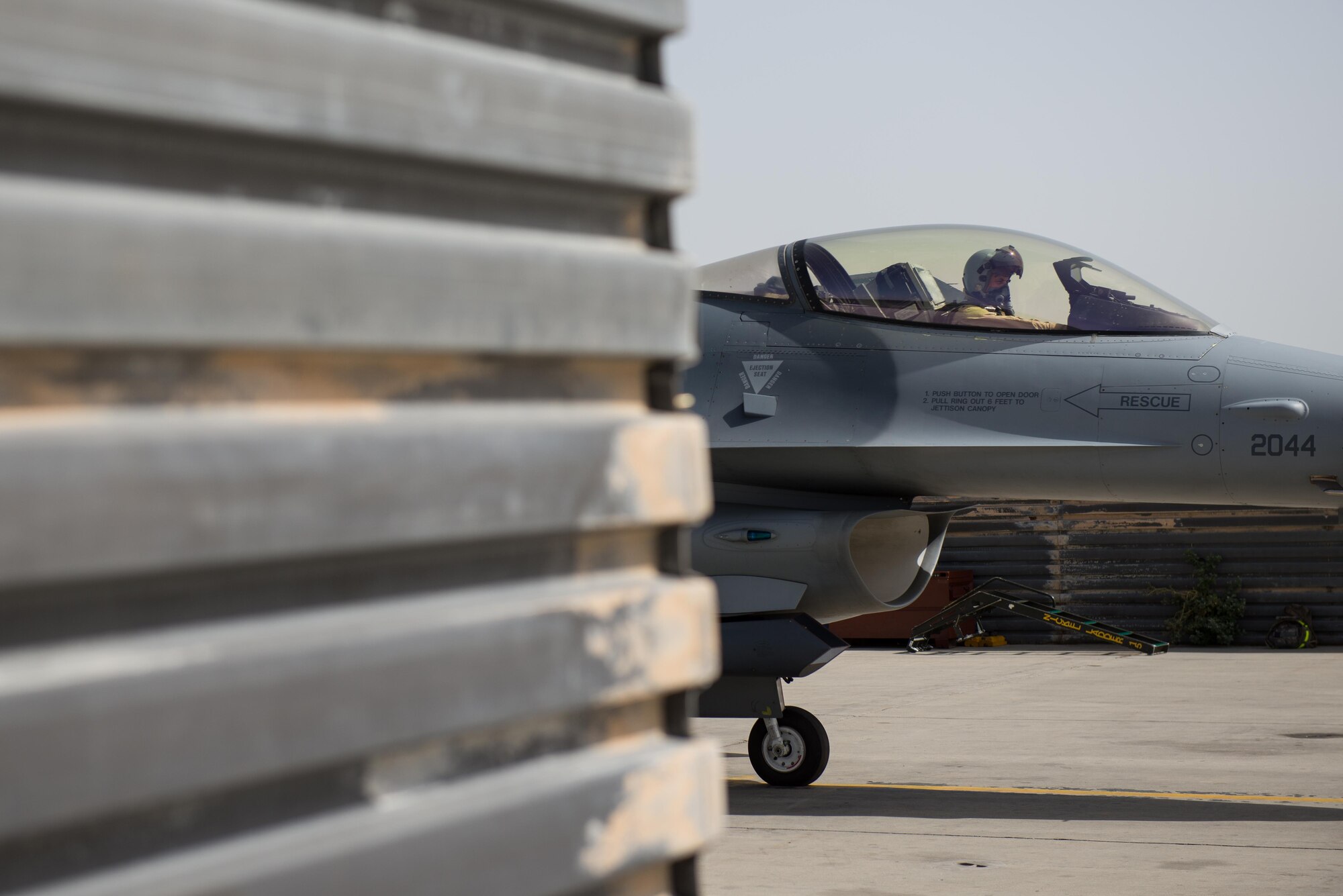 U.S. Air Force Brig. Gen. Dave Julazadeh, 455th Air Expeditionary Wing commander, goes over preflight checks in an F-16 Fighting Falcon aircraft before flying a combat sortie July 7, 2015, at Bagram Airfield, Afghanistan. Julazadeh was flying his first combat sortie as commander of the 455th AEW. (U.S. Air Force photo by Tech. Sgt. Joseph Swafford/Released)