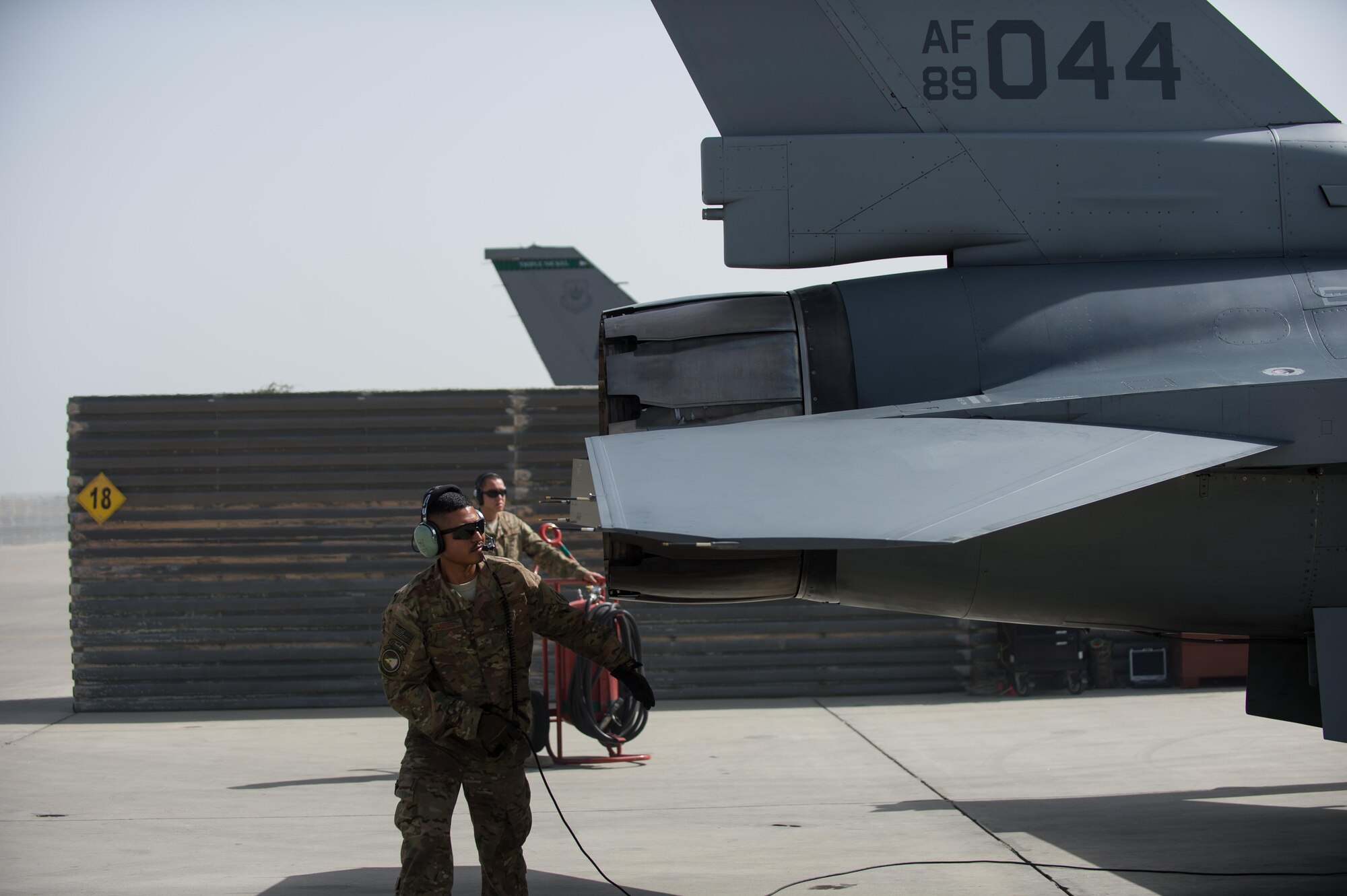 U.S. Air Force Airman 1st Class Manuel Jimenez, 455th Expeditionary Aircraft Maintenance Squadron crew chief, performs a preflight inspection on an F-16 Fighting Falcon aircraft at Bagram Airfield, Afghanistan, July 7, 2015. The F-16 is a multi-role fighter aircraft that is highly maneuverable and has proven itself in air-to-air and air-to-ground combat. (U.S. Air Force photo by Tech. Sgt. Joseph Swafford/Released)