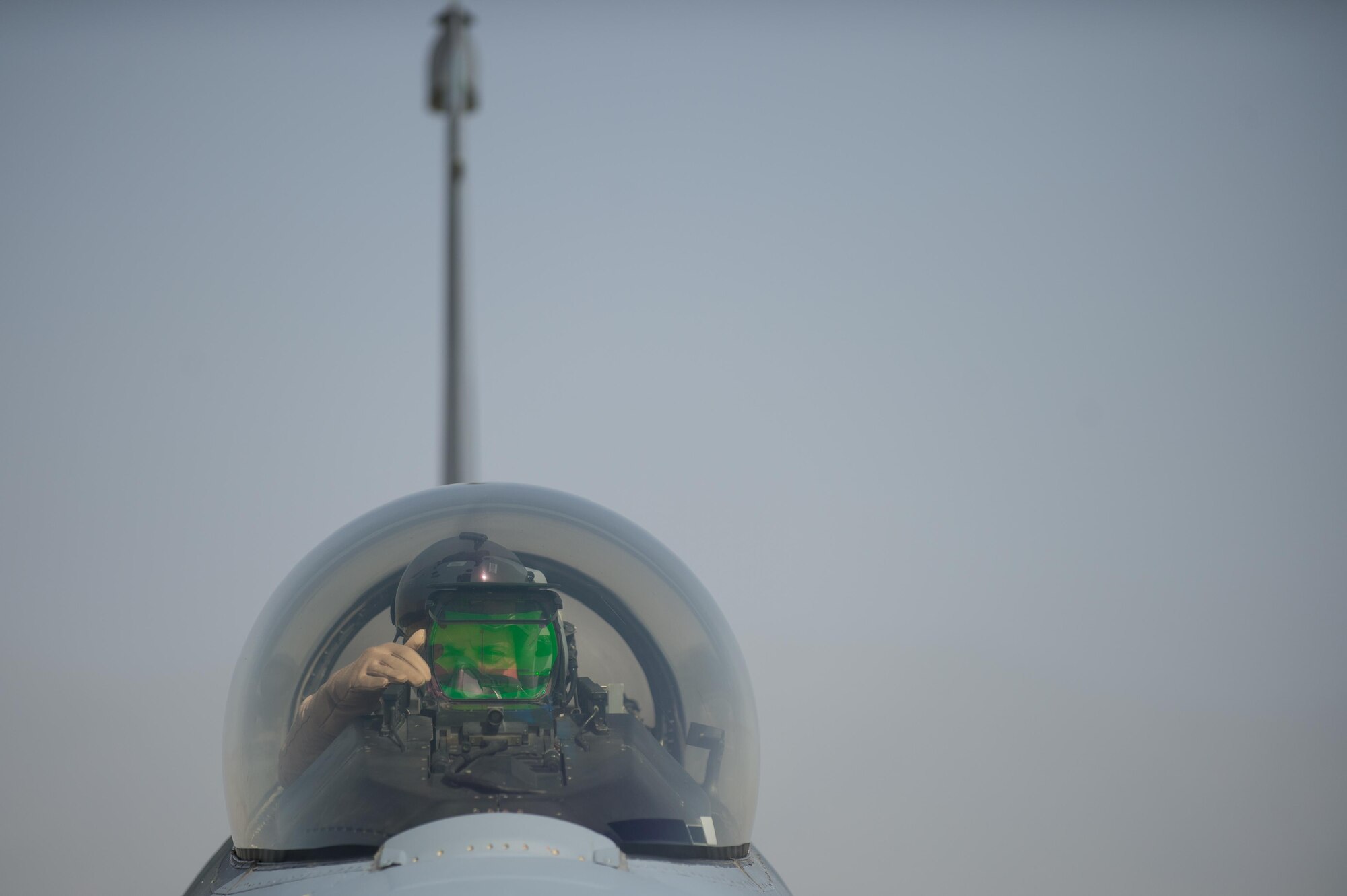 U.S. Air Force Brig. Gen. Dave Julazadeh, 455th Air Expeditionary Wing commander, goes over preflight checks in an F-16 Fighting Falcon aircraft before flying a combat sortie July 7, 2015, at Bagram Airfield, Afghanistan. Julazadeh was flying his first combat sortie as Commander of the 455th AEW. (U.S. Air Force photo by Tech. Sgt. Joseph Swafford/Released)