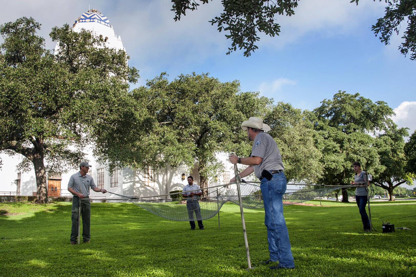 From left: Ted Pepps, Mike Pacheco and Brian Washburn, U.S. Department of Agriculture research biologists, demonstrate the proper way to set up an electromagnetic drop net June 23 at Joint Base San Antonio-Randolph as part of a study to reduce bird strikes on aircraft. For the complete story, see page 4.
Photo by Melissa Peterson
