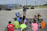 Kylie Knigge, Joint Base San Antonio-Randolph Youth Programs archery camp instructor, teaches camp participants about the use and handling of a bow June 26 at JBSA-Randolph.