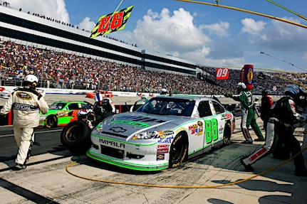 Dale Earnhardt Jr., driver of the No. 88 National Guard NASCAR racecar, makes a pit stop as his crew sprint around his car at the Dover International Speedway in Dover, Delaware May7, 2011. Jr. started the race in the third position and after battling the handling of his car all night, finished in 12th place. He is still in fourth place in the Sprint Cup series standings.