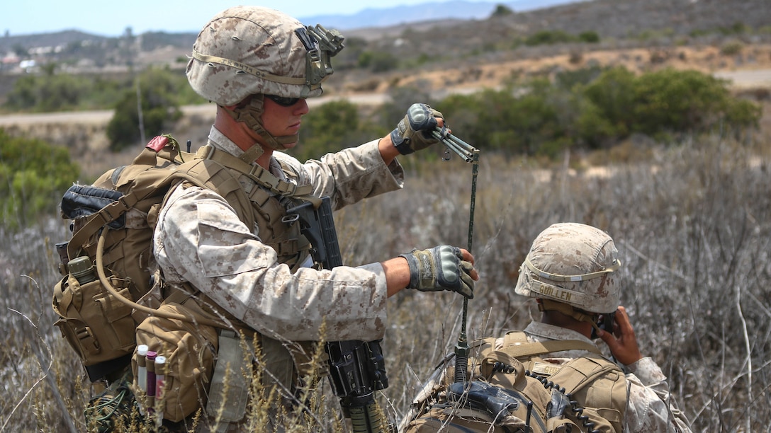Corporal Russell Robertson, a squad leader assigned to Company I, 3rd Battalion, 5th Marine Regiment, extends the antenna for his radio operator during the 1st Marine Division Super Squad Competition aboard Marine Corps Base Camp Pendleton, Calif., June 30, 2015. The Marines and Sailors tested their abilities to conduct infantry operations for the title of super squad.