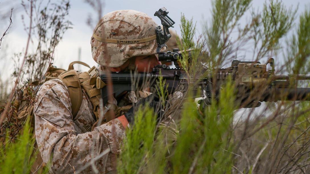 Lance Cpl. Patrick Murphy, a rifleman assigned to Company I, 3rd Battalion, 5th Marine Regiment, identifies a target through his rifle combat optic during a patrol as part of the 1st Marine Division Super Squad Competition aboard Marine Corps Base Camp Pendleton, Calif., June 30, 2015. The Marines and Sailors tested their abilities to conduct infantry operations for the title of super squad.