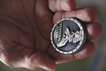 Lt. John Rolaf holds his Saint Michael coin, symbolizing law enforcement protection, which he always keeps in his pocket. 