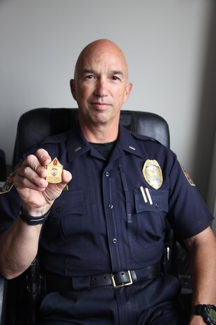 Lt. John Rolaf displays his personal coin he had made when he received the rank of master gunnery sergeant.  