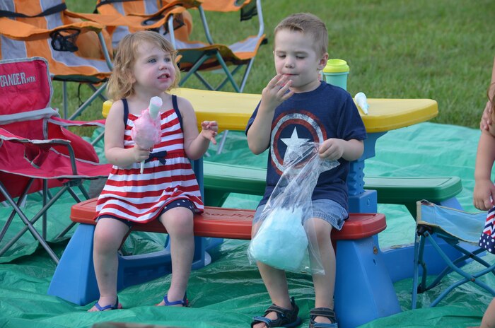 Jamie, 2, and Jackson, 3, enjoy cotton candy during the Independence Day festivities on the Lejeune Hall front lawn.