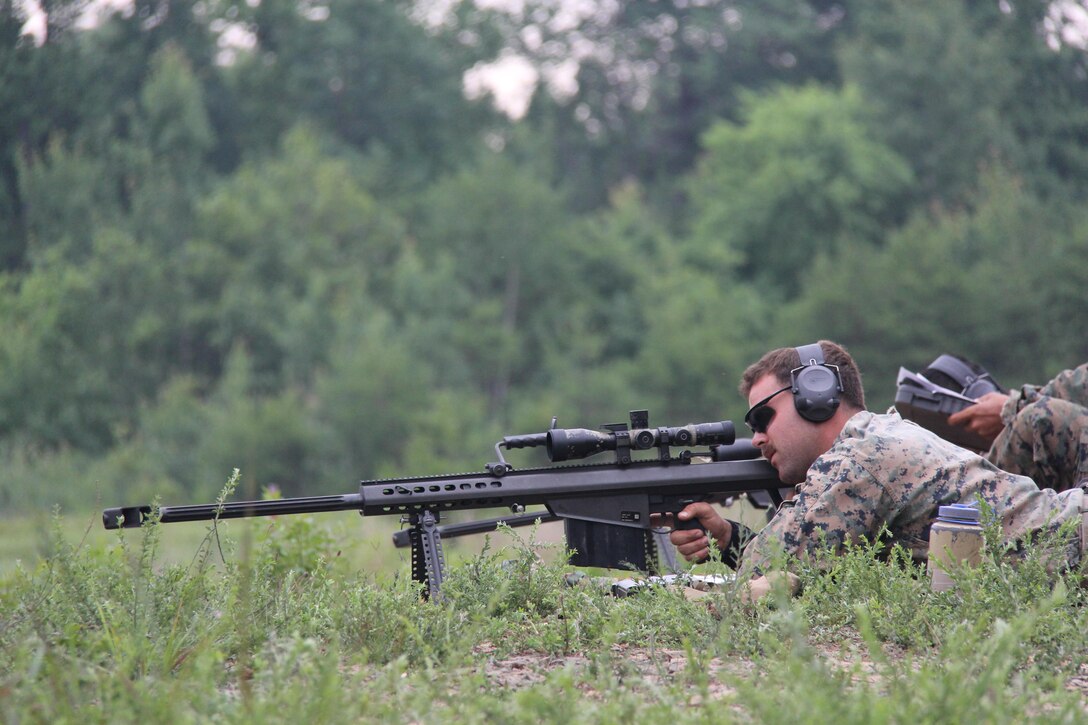 scout sniper student, fires a .50 caliber M107 special application scoped rifle during scout sniper training, July 2. The Scout Sniper Instructor School is part of the Weapon’s Training Battalion aboard Marine Corps Base Quantico.