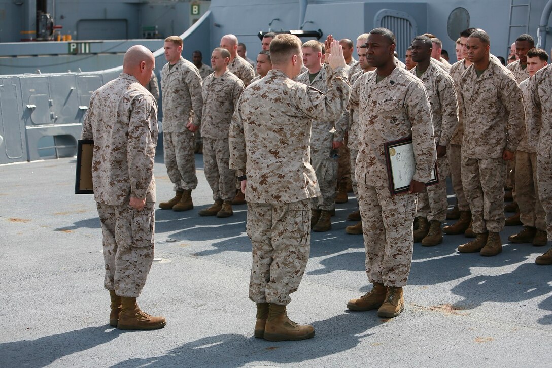 GULF OF ADEN (July 1, 2015) U.S. Marine Gunnery Sgt. Michael Washington, right, recites the oath of enlistment during his promotion ceremony on the forecastle of the amphibious transport dock ship USS Anchorage (LPD 23). Washington is the company gunnery sergeant for Headquarters and Service Company, Battalion Landing Team 3rd Battalion, 1st Marine Regiment, 15th Marine Expeditionary Unit. Anchorage is part of the Essex Amphibious Ready Group and, with the embarked 15th Marine Expeditionary Unit, is deployed in support of maritime security operations and theater security cooperation efforts in the U.S. 5th Fleet area of operations. (U.S. Marine Corps photo by Sgt. Steve H. Lopez/ Released)