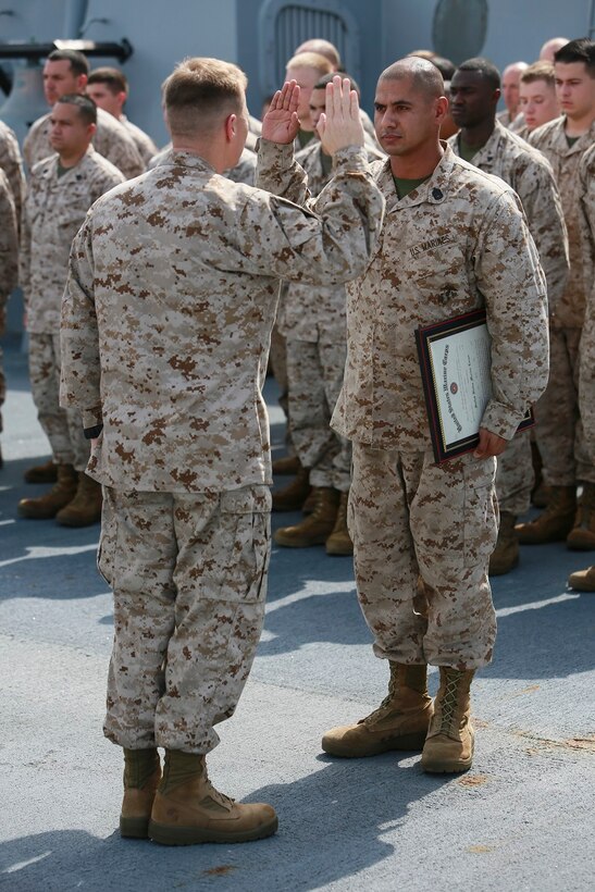 GULF OF ADEN (July 1, 2015) U.S. Marine Gunnery Sgt. Carlos Gonzalez, right, recites the oath of enlistment during his promotion ceremony on the forecastle of the amphibious transport dock ship USS Anchorage (LPD 23). Gonzalez is a platoon sergeant with India Company, Battalion Landing Team 3rd Battalion, 1st Marine Regiment, 15th Marine Expeditionary Unit. Anchorage is part of the Essex Amphibious Ready Group and, with the embarked 15th Marine Expeditionary Unit, is deployed in support of maritime security operations and theater security cooperation efforts in the U.S. 5th Fleet area of operations.  (U.S. Marine Corps photo by Sgt. Steve H. Lopez/ Released)