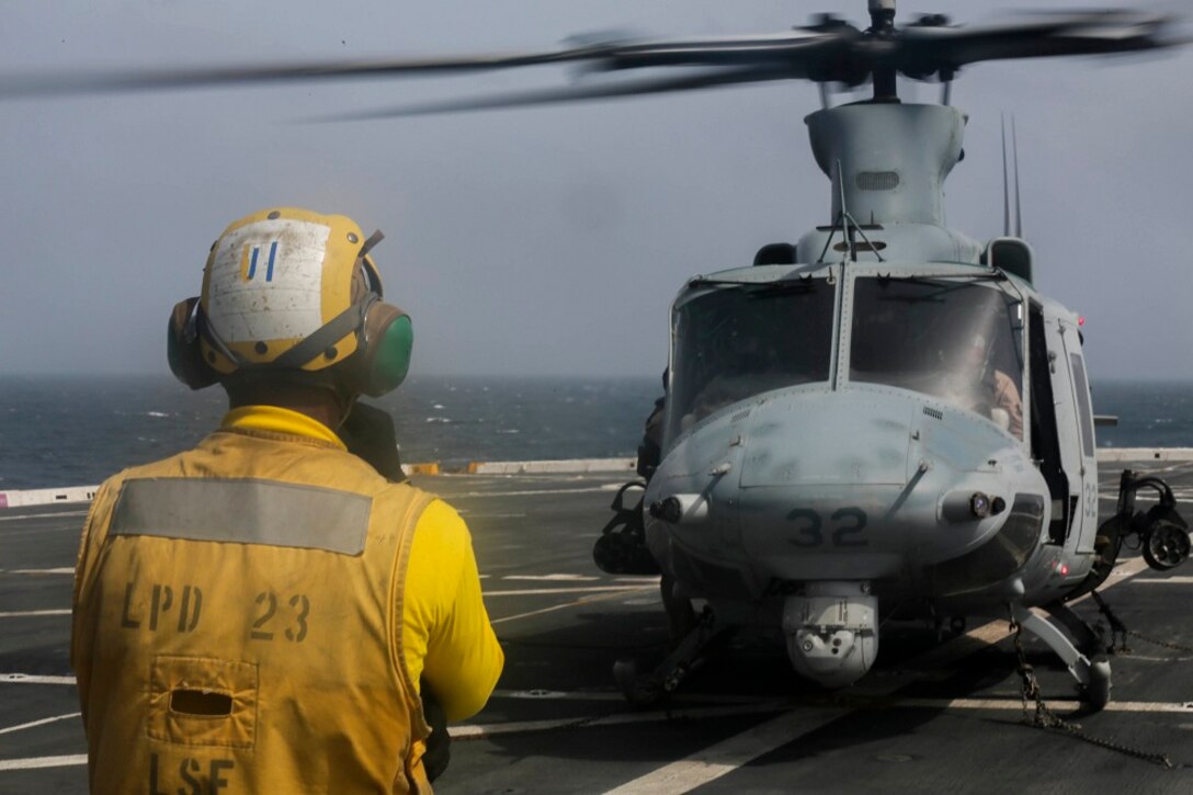 ARABIAN SEA (July 6, 2015) A U.S. Sailor gives a hold signal to the pilots of a UH-1Y Venom from the “Greyhawks” of  Marine Medium Tiltrotor Squadron 161 (Reinforced), 15th Marine Expeditionary Unit, during flight quarters aboard the amphibious transport dock USS Anchorage (LPD 23).  Anchorage is part of the Essex Amphibious Ready Group and, with the embarked 15th MEU, is deployed in support of maritime security operations and theater security cooperation efforts in the U.S. 5th Fleet area of operations. (U.S. Marine Corps photo by Sgt. Jamean Berry/ Released)