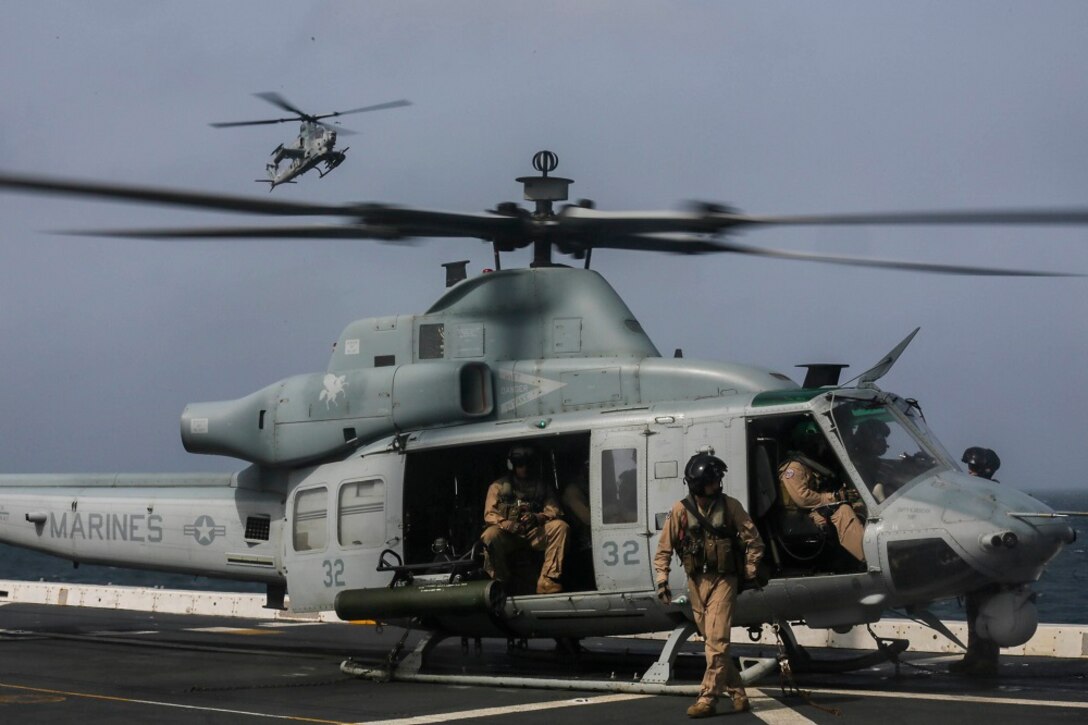 ARABIAN SEA (July 6, 2015) U.S. Marines prepare a UH-1Y Venom from the “Greyhawks” of Marine Medium Tiltrotor Squadron 161 (Reinforced), 15th Marine Expeditionary Unit, for take-off during flight quarters aboard the amphibious transport dock USS Anchorage (LPD 23). The “Greyhawks” are the air combat element of the 15th MEU, and embarked aboard the ships of the Essex Amphibious Ready Group, are deployed in support of maritime security operations and theater security cooperation efforts in the U.S. 5th Fleet area of operations. (U.S. Marine Corps photo by Sgt. Jamean Berry/ Released)