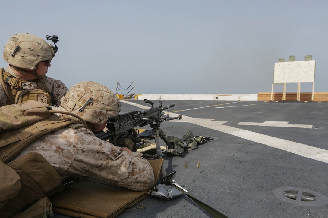 GULF OF ADEN (July 2, 2015) U.S. Marine Lance Cpl. Demitri Evert fires an M249 Squad Automatic Weapon aboard the amphibious transport dock USS Anchorage (LPD 23). Evert is a machine gunner with Battalion Landing Team 3rd Battalion, 1st Marine Regiment, 15th Marine Expeditionary Unit.  The Anchorage is part of the Essex Amphibious Ready Group and, with the embarked 15th Marine Expeditionary Unit, is deployed in support of maritime security operations and theater security cooperation efforts in the U.S. 5th Fleet area of operations. (U.S. Marine Corps photo by Sgt. Jamean Berry/Released)