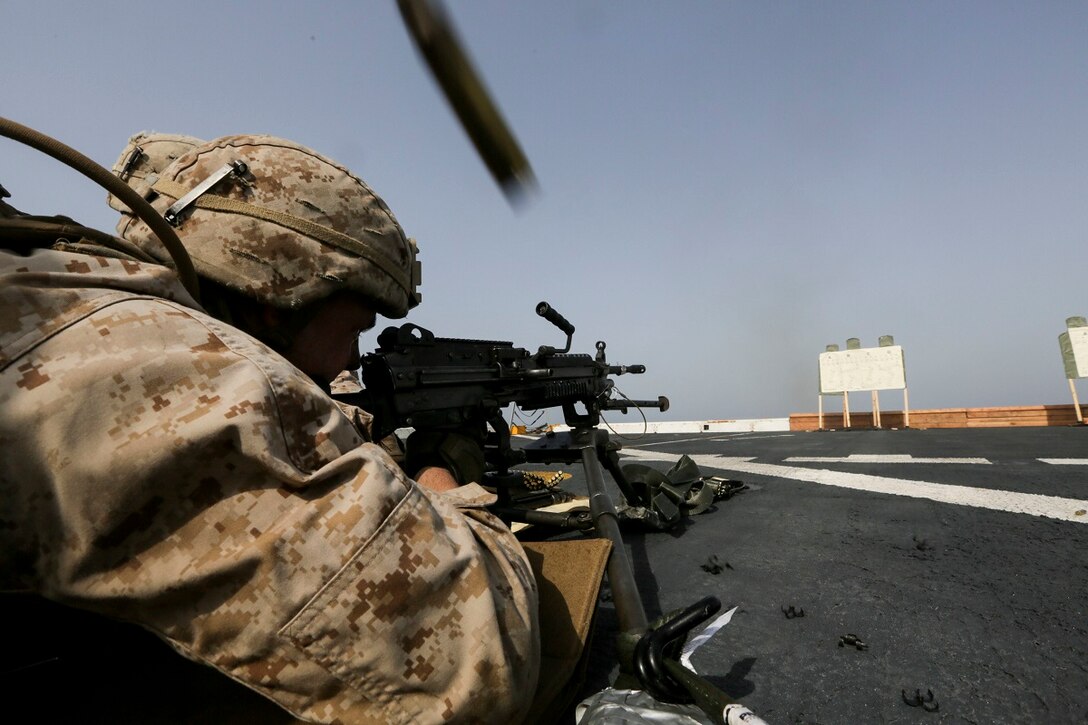 GULF OF ADEN (July 2, 2015) U.S. Marine Lance Cpl. Taylor Baur fires an M249 Squad Automatic Weapon aboard the amphibious transport dock USS Anchorage (LPD 23).  Baur is a machine gunner with Battalion Landing Team 3rd Battalion, 1st Marine Regiment, 15th Marine Expeditionary Unit. The Anchorage is part of the Essex Amphibious Ready Group and, with the embarked 15th Marine Expeditionary Unit, is deployed in support of maritime security operations and theater security cooperation efforts in the U.S. 5th Fleet area of operations. (U.S. Marine Corps photo by Sgt. Jamean Berry/Released)