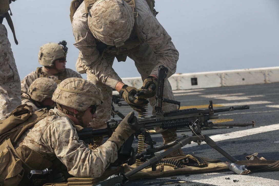 GULF OF ADEN (July 2, 2015) U.S. Marine Lance Cpl. Taylor Baur loads an M249 Squad Automatic Weapon aboard the amphibious transport dock USS Anchorage (LPD 23).  Baur is a machine gunner with Battalion Landing Team 3rd Battalion, 1st Marine Regiment, 15th Marine Expeditionary Unit.  The Anchorage is part of the Essex Amphibious Ready Group and, with the embarked 15th Marine Expeditionary Unit, is deployed in support of maritime security operations and theater security cooperation efforts in the U.S. 5th Fleet area of operations. (U.S. Marine Corps photo by Sgt. Jamean Berry/Released)