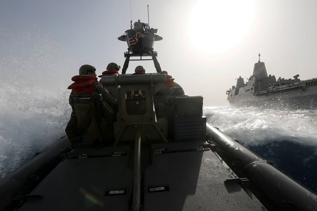 GULF OF ADEN (July 2, 2015) A rigid-hulled inflatable boat speeds past the amphibious transport dock USS Anchorage (LPD 23) during high-speed maneuvering drills. The Anchorage is part of the Essex Amphibious Ready Group and, with the embarked 15th Marine Expeditionary Unit, is deployed in support of maritime security operations and theater security cooperation efforts in the U.S. 5th Fleet area of operations. (U.S. Marine Corps photo by Sgt. Jamean Berry/Released)