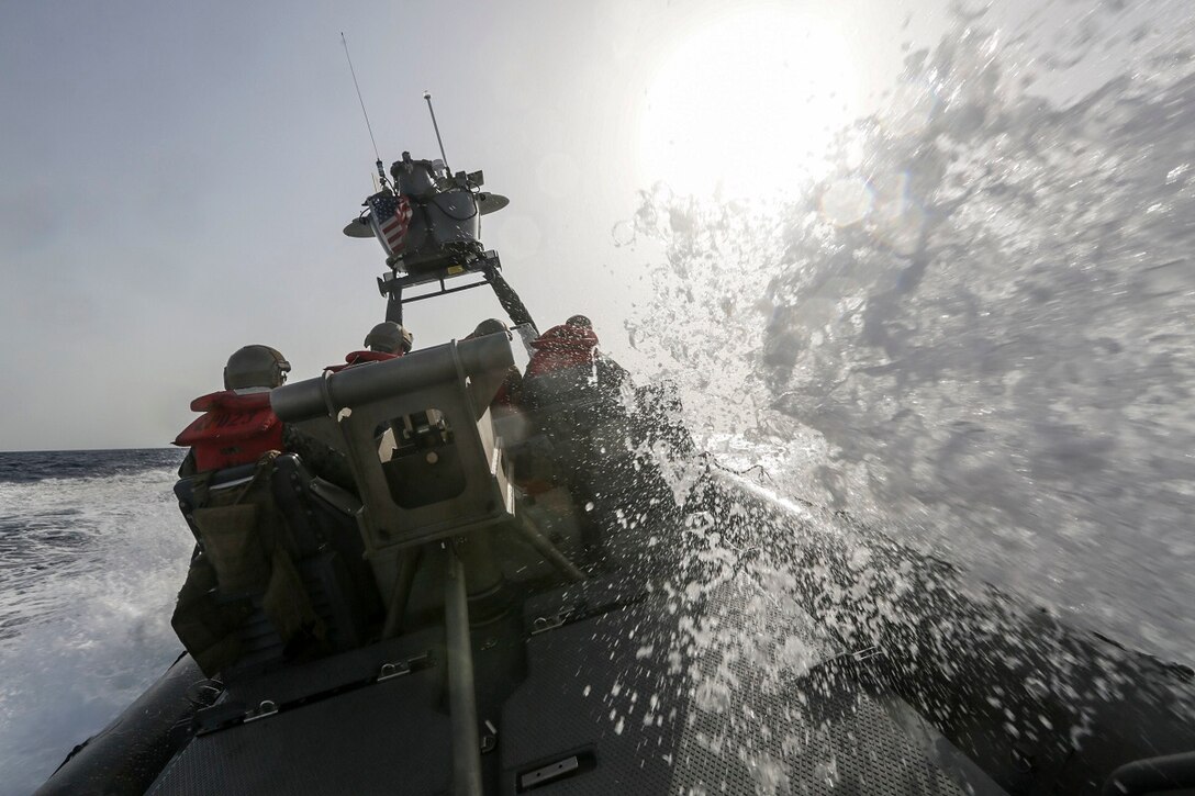 GULF OF ADEN (July 2, 2015) A wave crashes on a rigid-hulled inflatable boat while conducting high-speed maneuvering drills near the amphibious transport dock USS Anchorage (LPD 23). The Anchorage is part of the Essex Amphibious Ready Group and, with the embarked 15th Marine Expeditionary Unit, is deployed in support of maritime security operations and theater security cooperation efforts in the U.S. 5th Fleet area of operations. (U.S. Marine Corps photo by Sgt. Jamean Berry/Released)