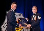 U.S. Air Force Tech. Sgt. David Maddeford receives his Weapons School diploma from Col. Michael Drowley, Commandant, for USAF Weapons School, during a ceremony held June 27, 2015, in Las Vegas. Maddeford, a Joint Terminal Attack Controller (JTAC) with the 118th Air Support Operations Squadron, New London, North Carolina, was also one of five enlisted JTACs who made history by being the first enlisted graduates awarded the coveted graduate patch and enter into an elite group of “patch wearer” brethren.