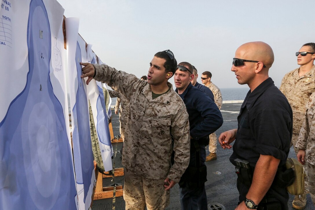 GULF OF ADEN (July 2, 2015) U.S. Marines with the 15th Marine Expeditionary Unit’s Maritime Raid Force assist the visit, board, search, and seizure team aboard the amphibious transport dock USS Anchorage (LPD 23) in maintaining proficiency with their weapons.  The Anchorage is part of the Essex Amphibious Ready Group and, with the embarked 15th Marine Expeditionary Unit, is deployed in support of maritime security operations and theater security cooperation efforts in the U.S. 5th Fleet area of operations. (U.S. Marine Corps photo by Sgt. Jamean Berry/Released)
