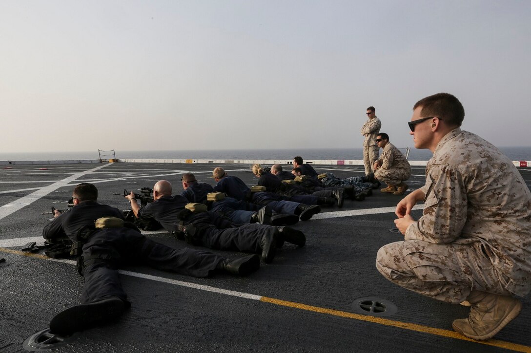 GULF OF ADEN (July 2, 2015) U.S. Marines with the 15th Marine Expeditionary Unit’s Maritime Raid Force assist the visit, board, search, and seizure team aboard the amphibious transport dock USS Anchorage (LPD 23) in maintaining proficiency with their weapons. The Anchorage is part of the Essex Amphibious Ready Group and, with the embarked 15th Marine Expeditionary Unit, is deployed in support of maritime security operations and theater security cooperation efforts in the U.S. 5th Fleet area of operations. (U.S. Marine Corps photo by Sgt. Jamean Berry/Released)
