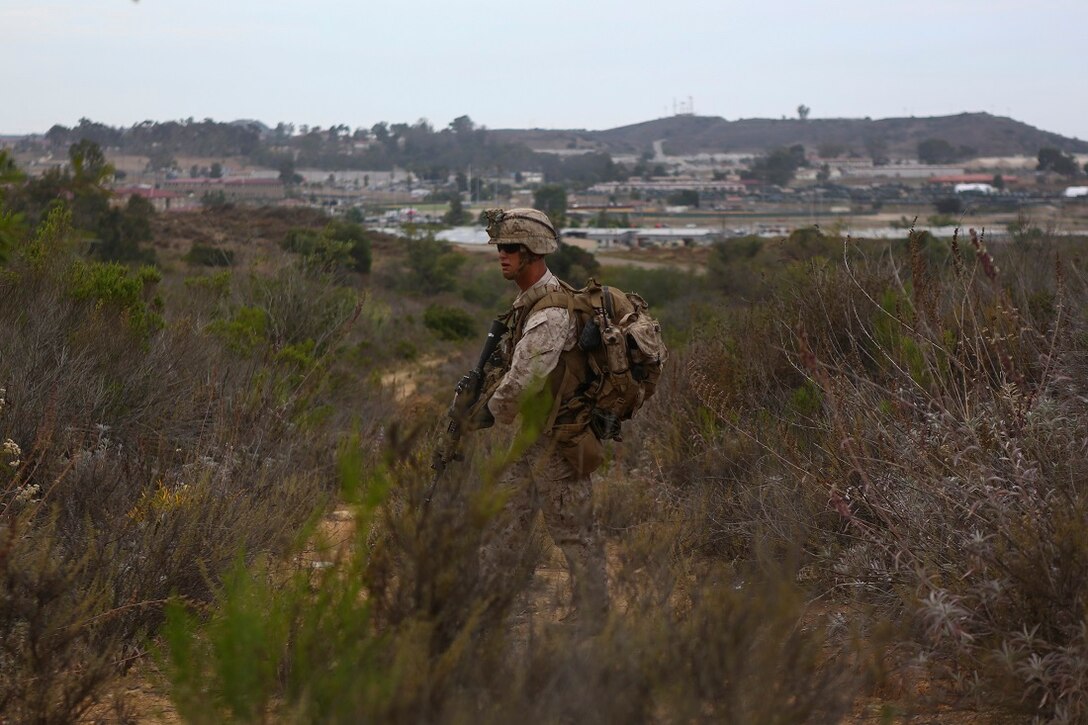 Corporal Russell Robertson, a squad leader assigned to Company I, 3rd Battalion, 5th Marine Regiment, patrols through brush during the patrolling portion of the 1st Marine Division Super Squad Competition aboard Marine Corps Base Camp Pendleton, Calif., June 30, 2015. The Marines and Sailors tested their abilities to conduct infantry operations for the title of super squad.