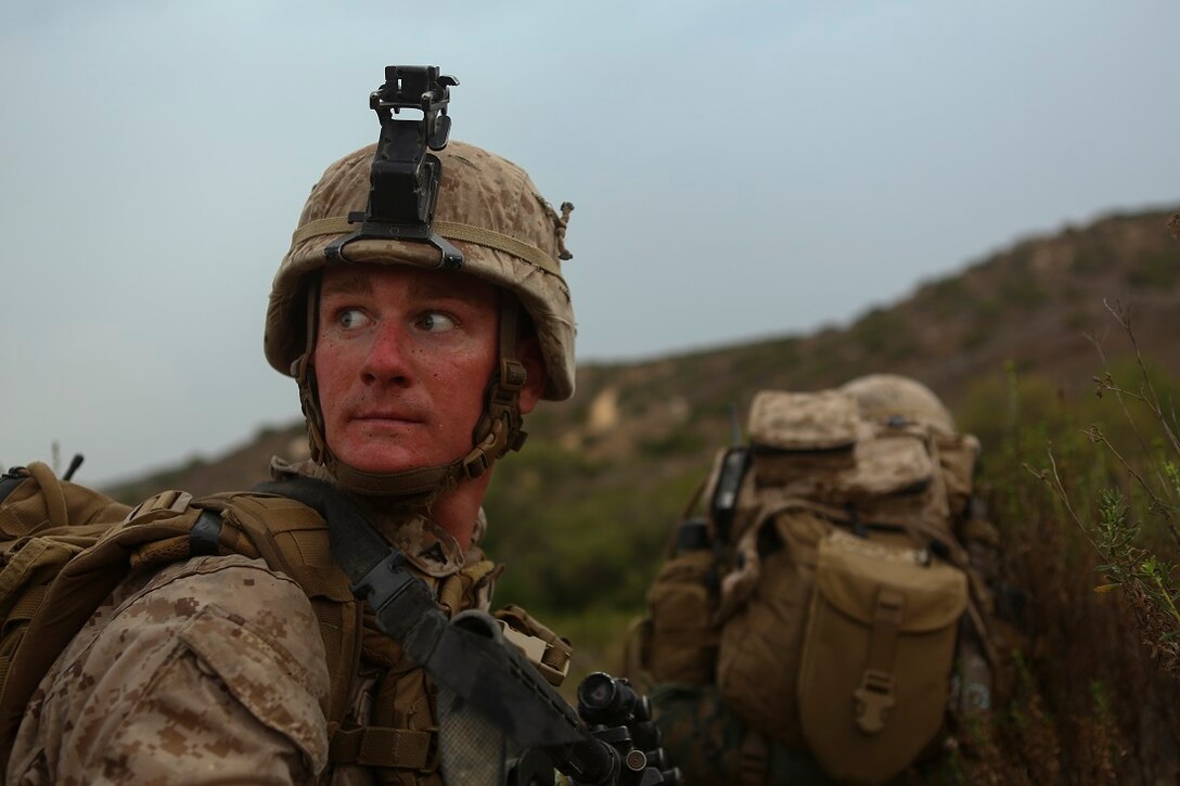 Lance Cpl. Cory Mersino, a team leader assigned to Company I, 3rd Battalion, 5th Marine Regiment, looks over his shoulder at his surroundings during a patrol as part of the 1st Marine Division Super Squad Competition aboard Marine Corps Base Camp Pendleton, Calif., June 30, 2015. The Marines and Sailors tested their abilities to conduct infantry operations for the title of super squad.