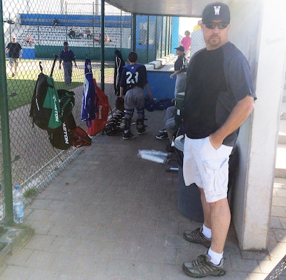 Assistant coach Stephen Swint is seen in the dugout during a game against the Stuttgart Reds in May at the Newman Village sports complex on Clay Kaserne, Germany. Swint, a project manager for U.S. Army Corps of Engineers Europe District, volunteered his time this past spring with the startup Wiesbaden Red Barons Baseball Club. He also was an assistant for a CYS team at U.S. Army Garrison Wiesbaden.