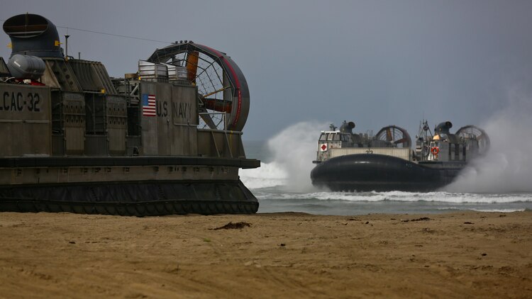 U.S. Navy Landing Craft Air Cushioned (LCAC) vehicle from Assault Craft Unit 5 lands on Red Beach as part of a loading exercise along side Combat Logistics Battalion 11, Headquarters Regiment, 1st Marine Logistics Group at Marine Corps Base Camp Pendleton, California, June 23, 2015. This loading exercise reinforces the Marine Corps role as an amphibious force in readiness by maintaining capabilities through realistic training. 