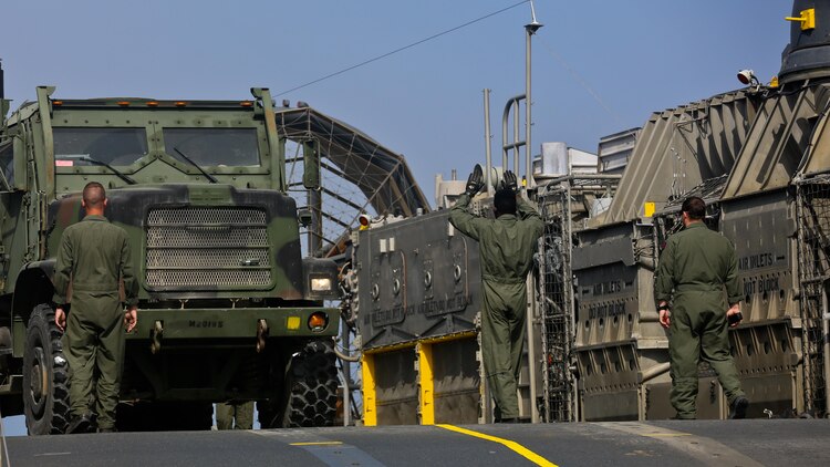 U.S. Navy Landing Craft Air Cushioned (LCAC) vehicle from Assault Craft Unit 5 unloads a U.S. Marine Medium Tactical Vehicle Replacement onto Red Beach as part of a loading exercise along side Combat Logistics Battalion 11, Headquarters Regiment, 1st Marine Logistics Group at Marine Corp Base Camp Pendleton, California, June 23, 2015. This loading exercise reinforces the Marine Corps role as an amphibious force in readiness by maintaining capabilities through realistic training. 