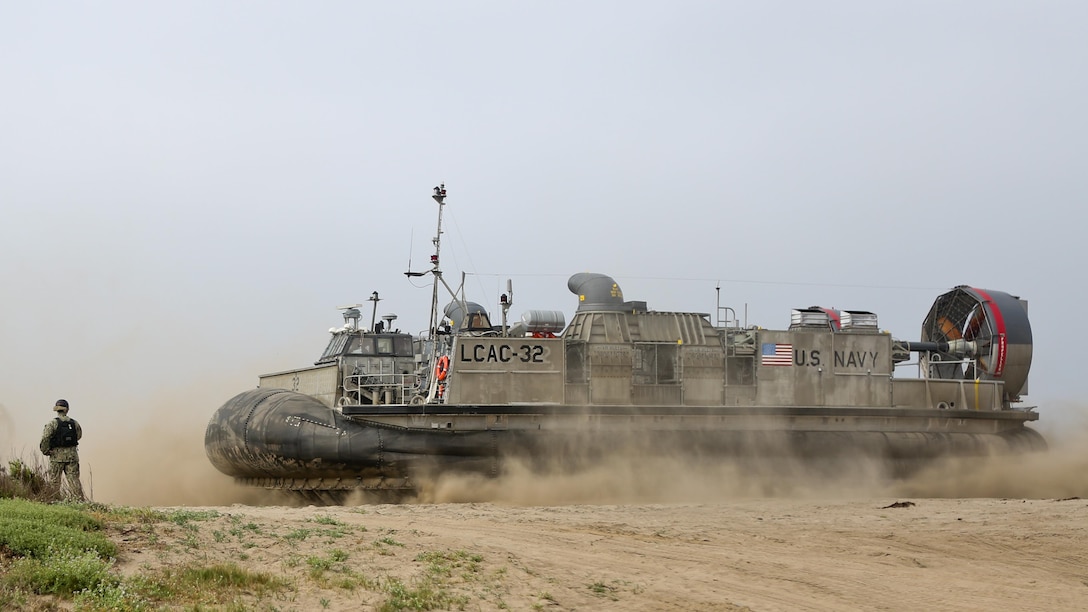 U.S. Navy Landing Craft Air Cushioned (LCAC) vehicle from Assault Craft Unit 5 lands on Red Beach as part of a loading exercise along side Combat Logistics Battalion 11, Headquarters Regiment, 1st Marine Logistics Group at Marine Corps Base Camp Pendleton, California, June 23, 2015. This loading exercise reinforces the Marine Corps role as an amphibious force in readiness by maintaining capabilities through realistic training. 