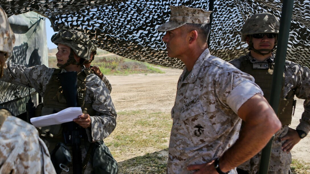 Colonel Phillip N. Frietze, Commanding Officer, Headquarters Regiment, 1st Marine Logistics Group, speaks with Marines of Combat Logistics Battalion 11, Headquarters Regiment, 1st Marine Logistics Group, during a loading exercise at Red Beach, Marine Corps Base Camp Pendleton, California, June 23, 2015. This loading exercise reinforces the Marine Corps' role as an amphibious force in readiness by maintaining capabilities through realistic training. 