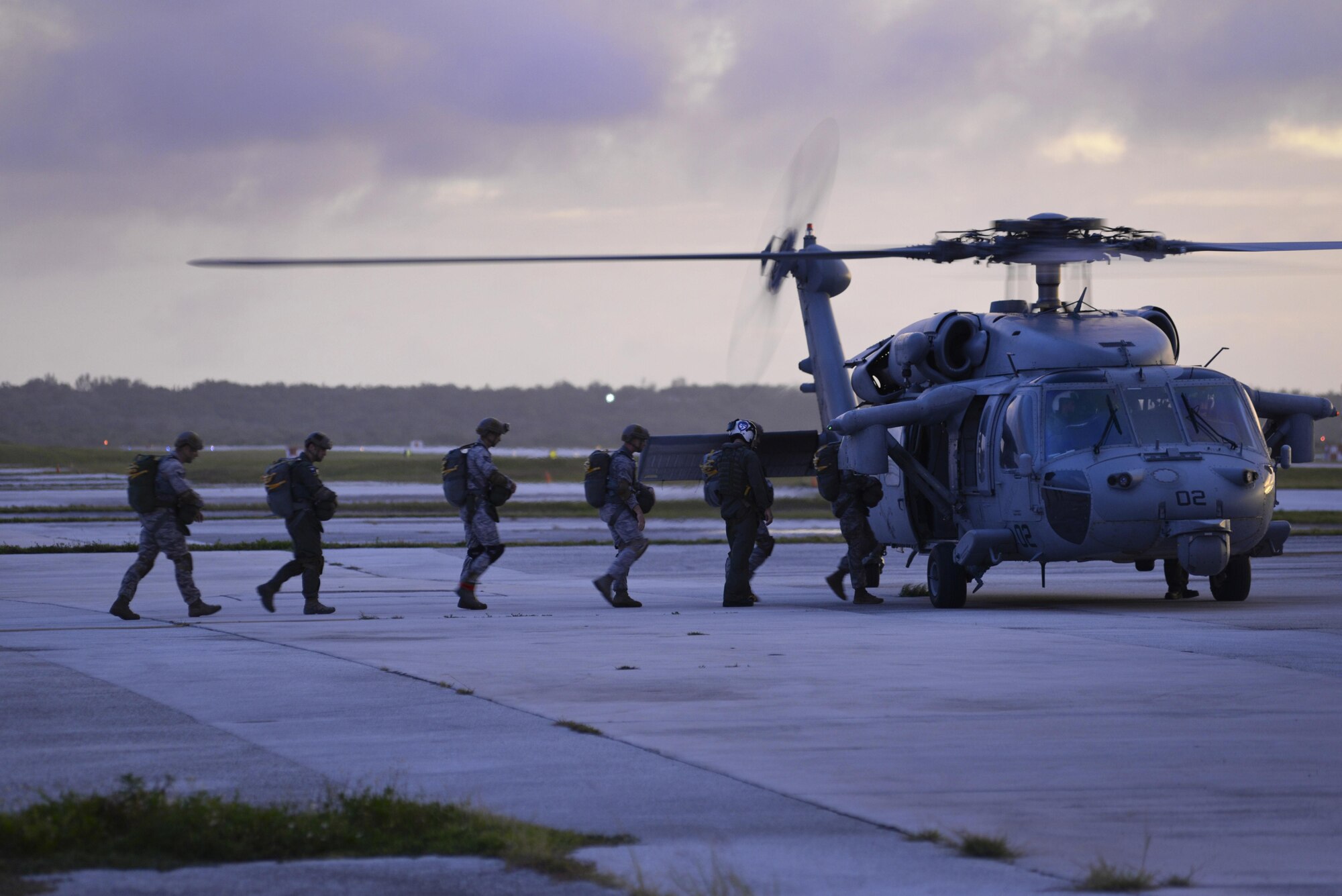 Members of the 736th Security Force Squadron board a MH-60 Sierra, assigned to Helicopter Sea Combat Squadron 25, July 3, 2015, at Andersen Air Force Base, Guam. HSC-25 provides vital airlift support to the 736th Security Forces Squadron, assisting with their quarterly static line parachute operations. (U.S. Air Force photo by Senior Airman Katrina M. Brisbin/Released)