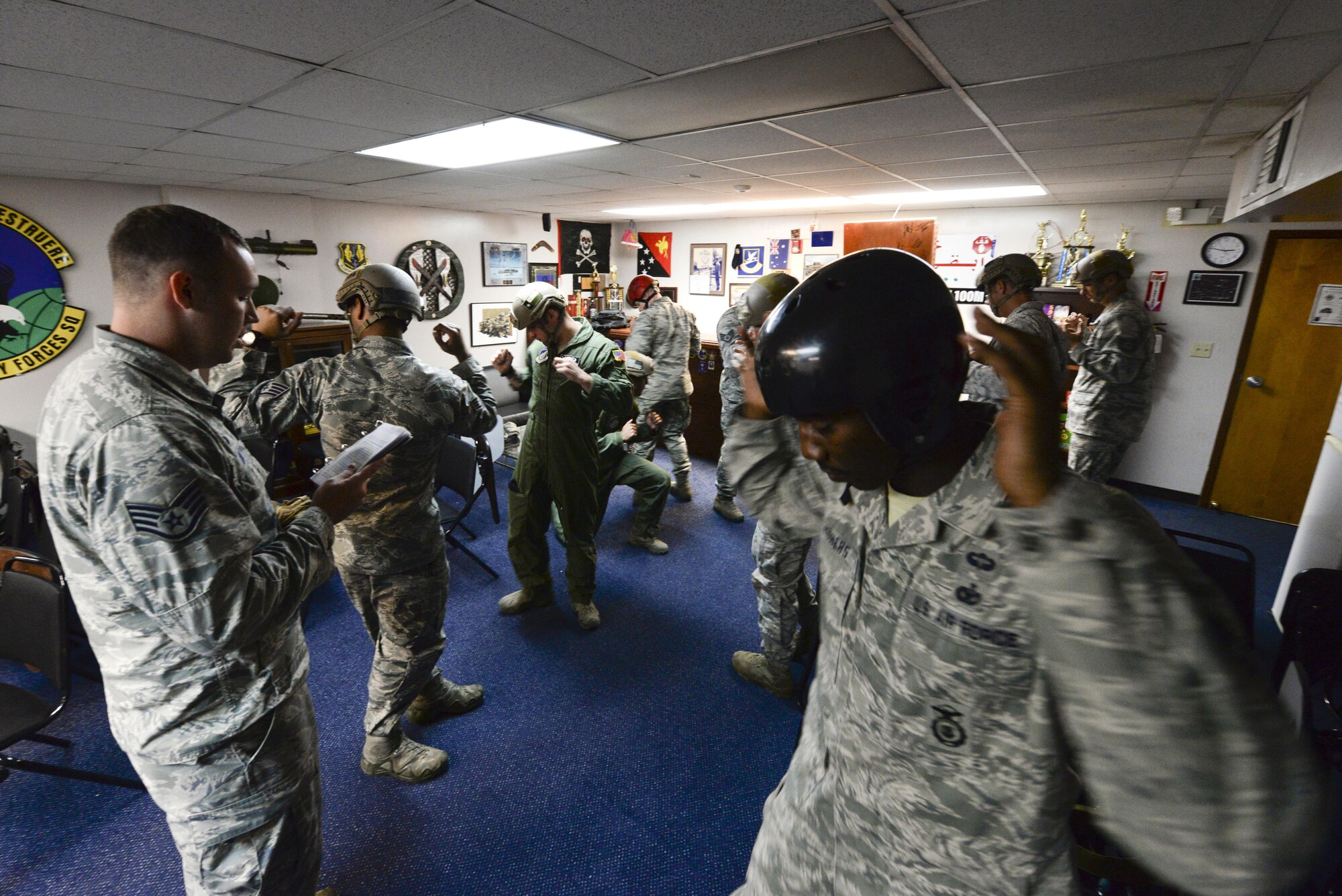 U.S. Air Force Airmen of the 736th Security Force Squadron review parachuting safety procedures July 3, 2015, at Andersen Air Force Base, Guam. The teams perform pre-jump training to review procedures they will use while in the aircraft during descent and how to react to any emergency that may occur. (U.S. Air Force photo by Senior Airman Katrina M. Brisbin/Released) 