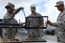 Airmen from the entomology flight of the 18th Civil Engineer Group show Chief Master Sgt. of the Air Force James Cody local snakes found on Kadena Air Base, Japan, July 8, 2015. As part of his ongoing initiative to engage Airmen around the globe, Cody will continue his tour throughout the Pacific Air Forces. (U.S. Air Force photo by Senior Airman Omari Bernard/Released)