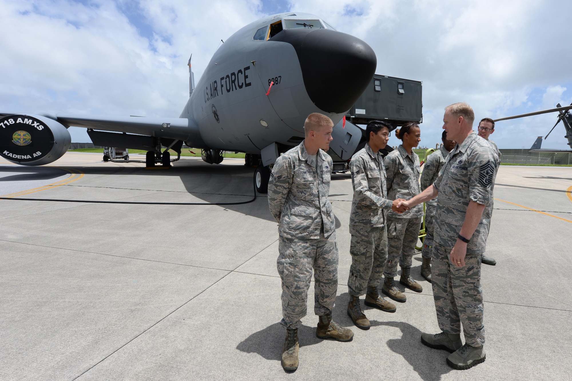 Chief Master Sgt. of the Air Force James Cody shakes hands with Airmen from the 18th Aeromedical Evacuation Squadron in front of a U.S. Air Force KC-135 Stratotanker on Kadena Air Base, Japan, July 8, 2015. As part of his ongoing initiative to engage Airmen around the globe, Cody will continue his tour throughout the Pacific Air Forces. (U.S. Air Force photo by Senior Airman Omari Bernard/Released)
