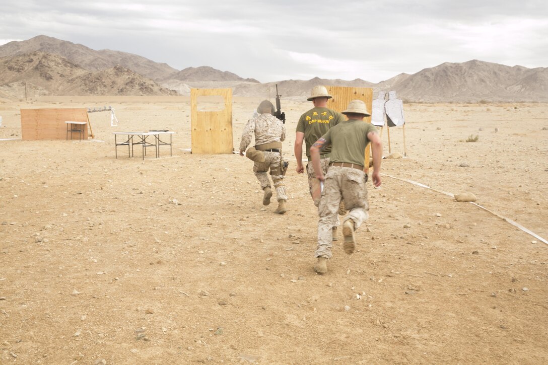 Cpl. Joseph Alvarez, aircraft rescue and firefighting, Marine Wing Support Squadron 372, Camp Pendleton, runs through the course of fire during the Western Regional Combat Match at the Combat Center Rifle Range, July 1, 2015. The courses created challenged the Marines to think quickly while handling weapons safely. (Official Marine Corps photo by Lance Cpl. Thomas Mudd/ Released)