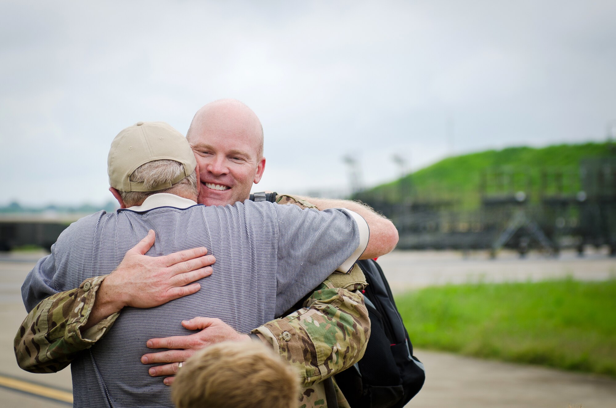 Lt. Col. Dave Flynn, a pilot in the 165th Airlift Squadron, embraces a family member during a homecoming ceremony at the Kentucky Air National Guard Base in Louisville, Ky., July 8, 2015. Flynn and 29 other Kentucky Air Guardsmen returned from a deployment to the Persian Gulf Region, where they’ve been supporting Operation Freedom’s Sentinel since February. (U.S. Air National Guard photo by Master Sgt. Phil Speck)